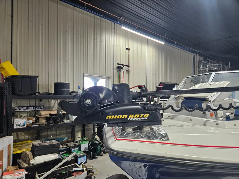 Slide: The Image of 1997 Yar-Craft 192 Michigan boat with Minn Kota Terrova motor in a garage setting. - 7