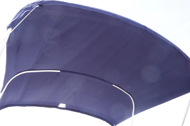 Slide: The Image of 2014 Monterey 196MS boat with blue stripes, parked on a road. - 11