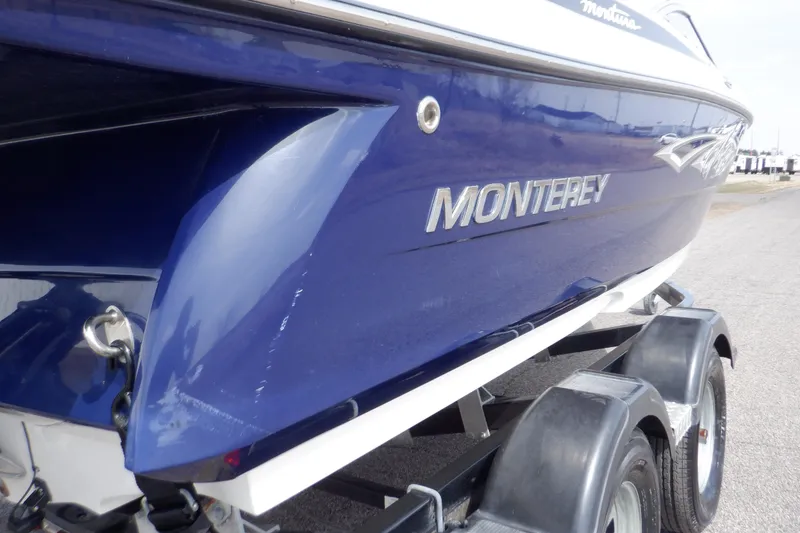 Slide: The Image of Close-up of a 2014 Monterey 196MS engine component with visible cables and rubber hose. - 14