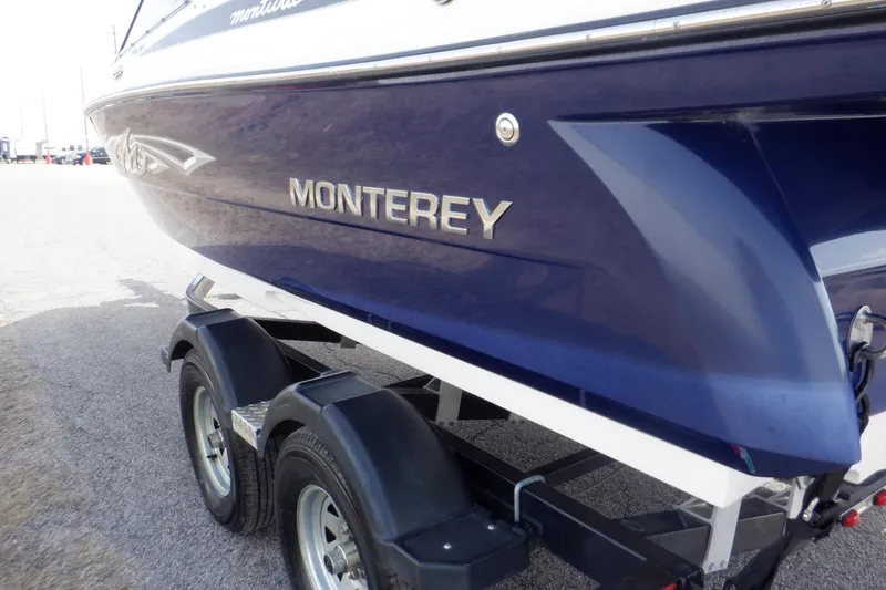 Slide: The Image of Blue 2014 Monterey 196MS boat with visible scratches and repair tool. - 17
