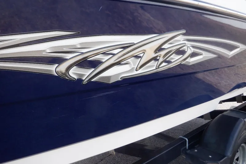 Slide: The Image of Close-up of a 2014 Monterey 196MS boat's blue hull with a cleaning tool. - 19