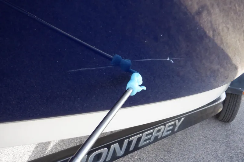 Slide: The Image of Close-up of a 2014 Monterey 196MS boat with a scratch being repaired. - 22