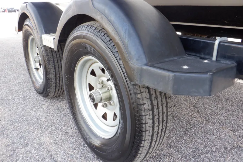 Slide: The Image of Close-up of 2014 Monterey 196MS trailer wheels on asphalt surface. - 29
