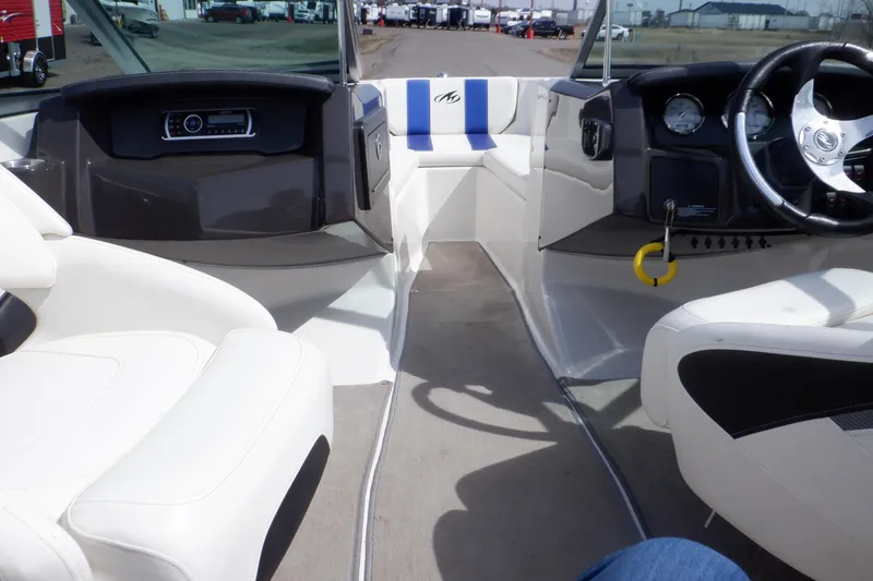 Slide: The Image of Interior of a 2014 Monterey 196MS boat with white and blue seating. - 50