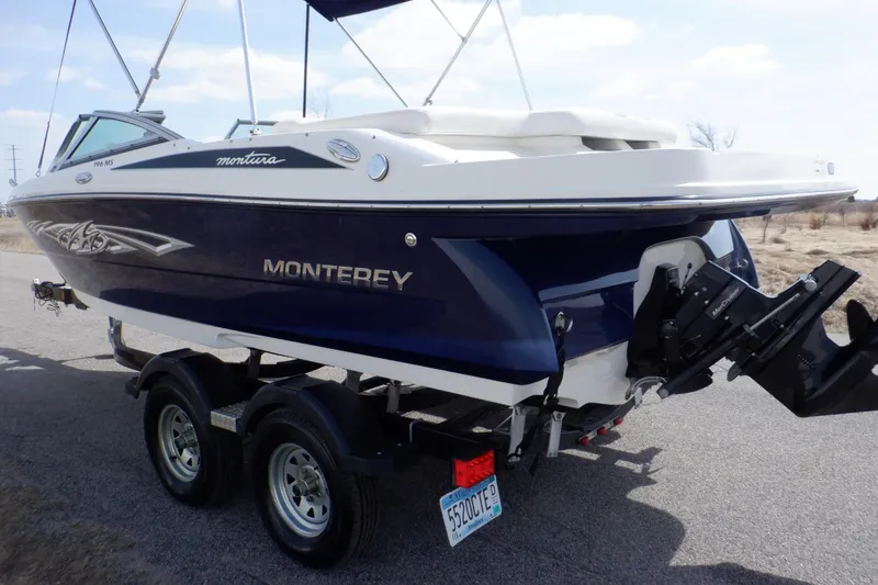 Slide: The Image of Rear view of a 2014 Monterey 196MS boat on a trailer, showcasing the propeller. - 6