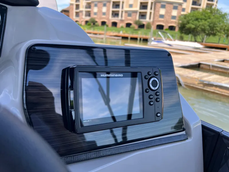Slide: The Image of Humminbird fish finder on 2025 Starcraft SLS 3 boat, docked near waterfront buildings. - 10