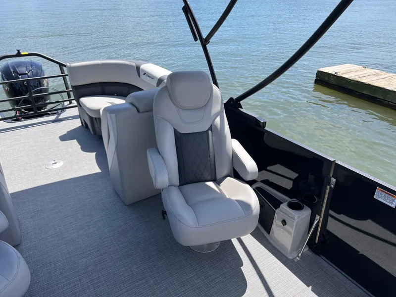 Slide: The Image of Luxurious seating on 2025 Starcraft SLS 3 boat, docked by serene water. - 11