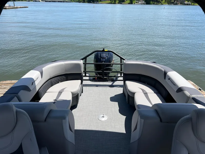 Slide: The Image of 2025 Starcraft SLS 3 pontoon boat interior with plush seating on a serene lake. - 12