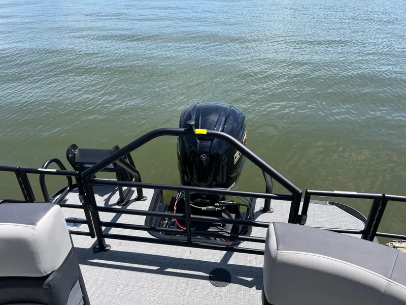 Slide: The Image of 2025 Starcraft SLS 3 boat with outboard motor on calm water. - 13