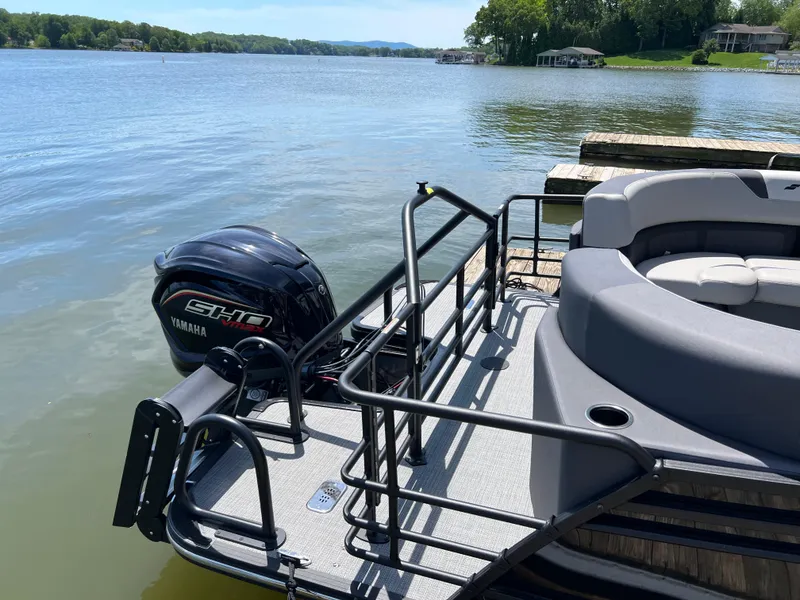 Slide: The Image of 2025 Starcraft SLS 3 pontoon boat with Yamaha engine docked by a serene lake. - 3