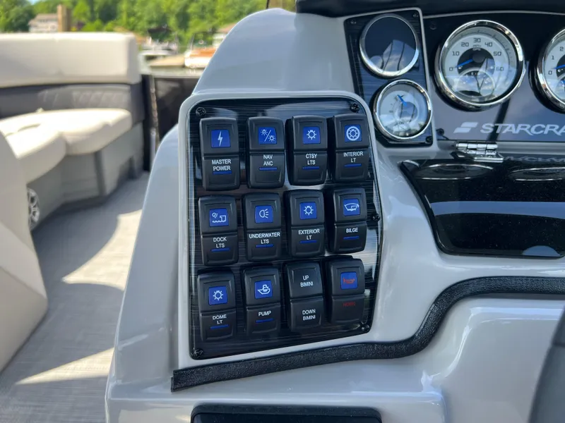 Slide: The Image of Control panel of a 2025 Starcraft SLS 3 boat with various switches and gauges. - 8