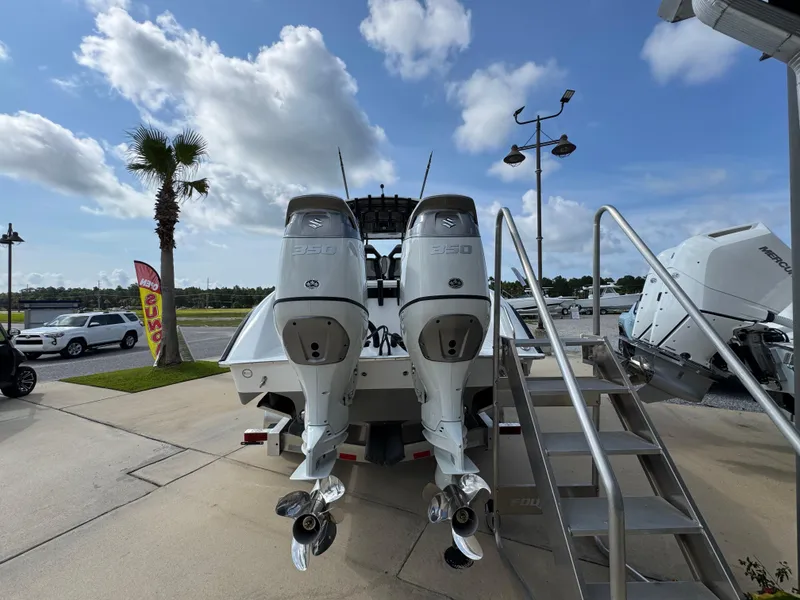 Slide: The Image of Cape Horn 32 XS 2025 boat with dual outboard engines, displayed outdoors under a cloudy sky. - 11