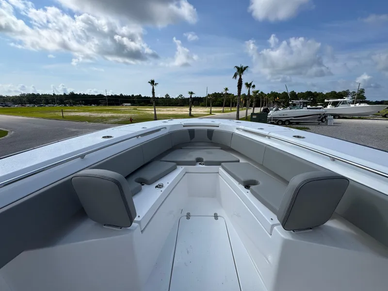 Slide: The Image of 2025 Cape Horn 32 XS boat interior with gray seating under a partly cloudy sky. - 16