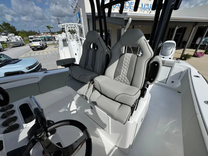Slide: The Image of 2025 Cape Horn 32 XS boat interior with dual gray seats and steering wheel. - 23