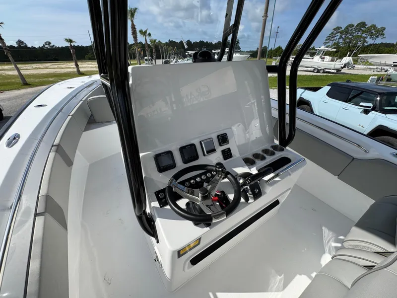 Slide: The Image of 2025 Cape Horn 32 XS boat console with steering wheel and controls. - 25