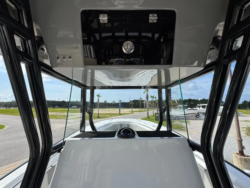 Slide: The Image of 2025 Cape Horn 32 XS boat interior with modern helm and panoramic view. - 27