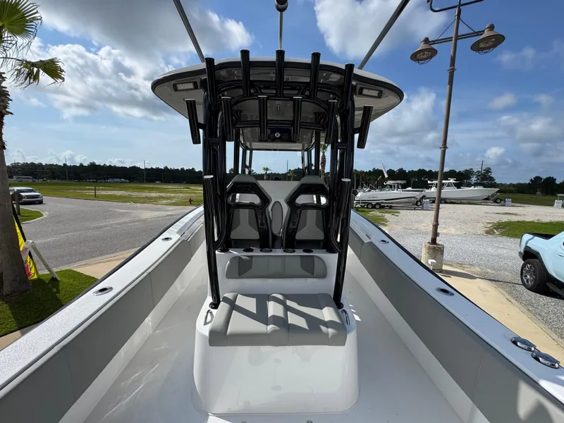 Slide: The Image of 2025 Cape Horn 32 XS boat with T-top and seating, parked outdoors under a cloudy sky. - 29