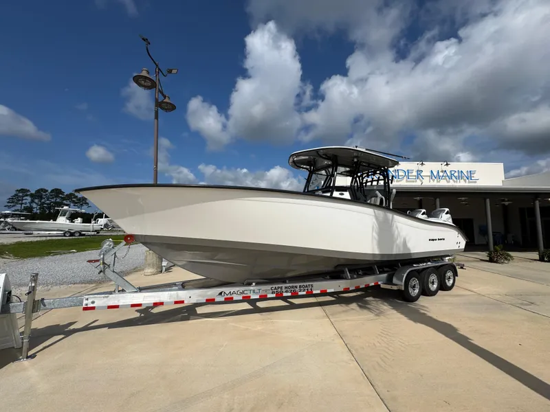 Slide: The Image of 2025 Cape Horn 32 XS boat on a trailer at a marine dealership. - 3