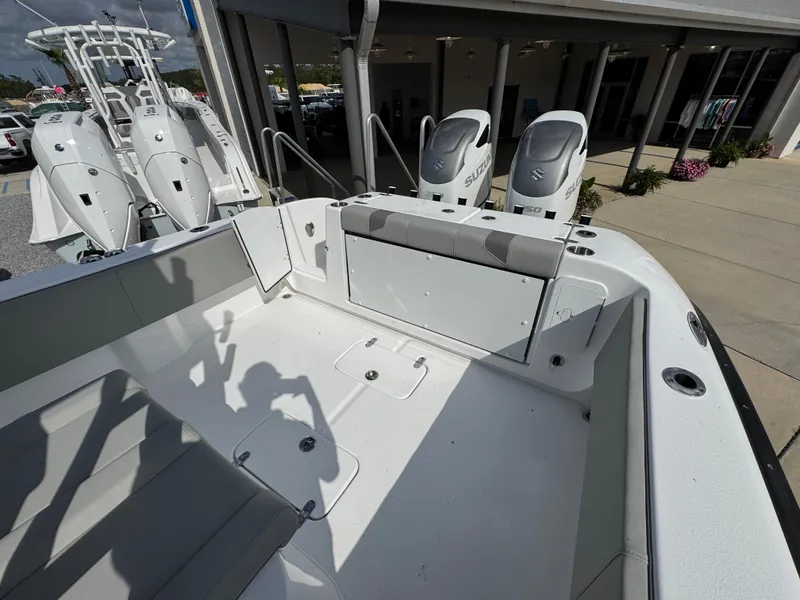 Slide: The Image of 2025 Cape Horn 32 XS boat with dual outboard engines, docked at a marina. - 30