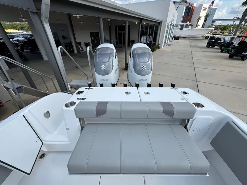 Slide: The Image of 2025 Cape Horn 32 XS boat with dual Suzuki engines, docked at a marina. - 32