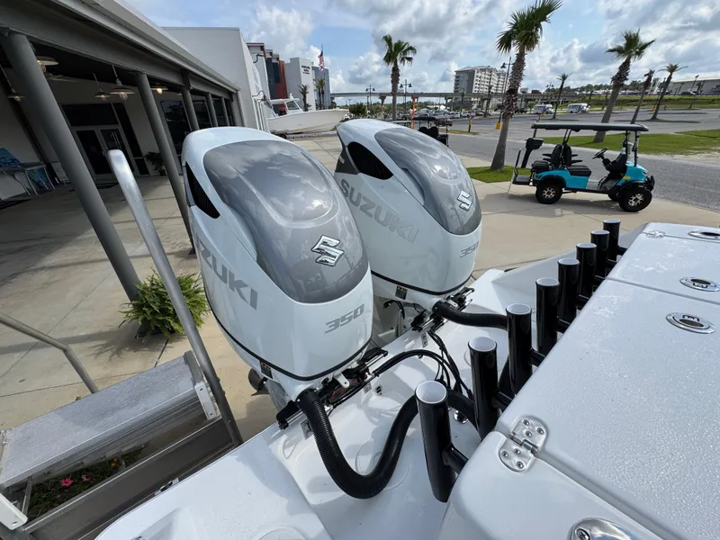 Slide: The Image of Twin Suzuki outboard engines on a 2025 Cape Horn 32 XS boat, dockside view. - 35