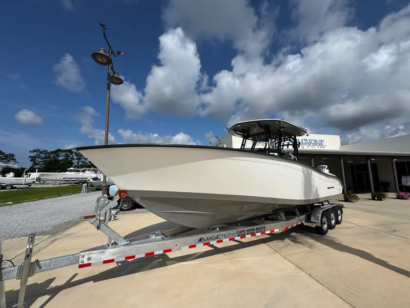 Slide: The Image of 2025 Cape Horn 32 XS boat on trailer under cloudy sky. - 4