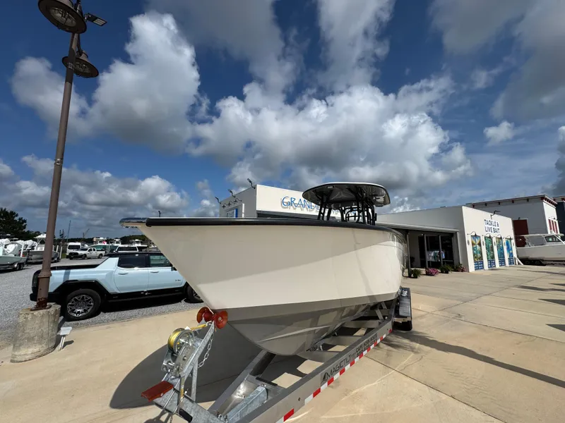 Slide: The Image of 2025 Cape Horn 32 XS boat on trailer under a cloudy sky at a dealership. - 5
