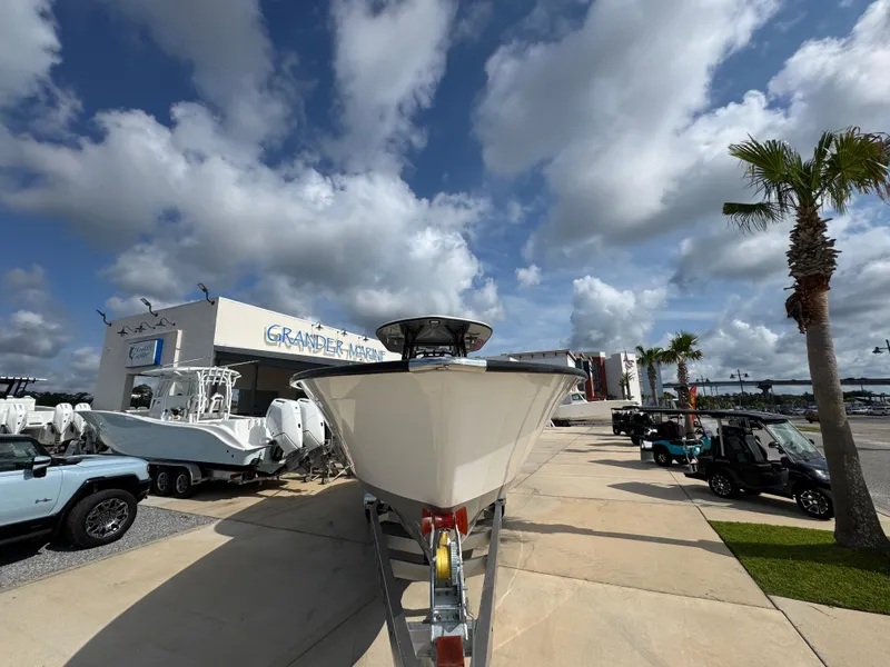 Slide: The Image of 2025 Cape Horn 32 XS boat on display at dealership under cloudy sky. - 6