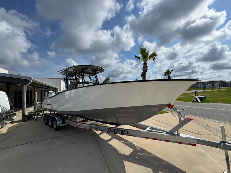 Slide: The Image of 2025 Cape Horn 32 XS boat on trailer under cloudy sky. - 7