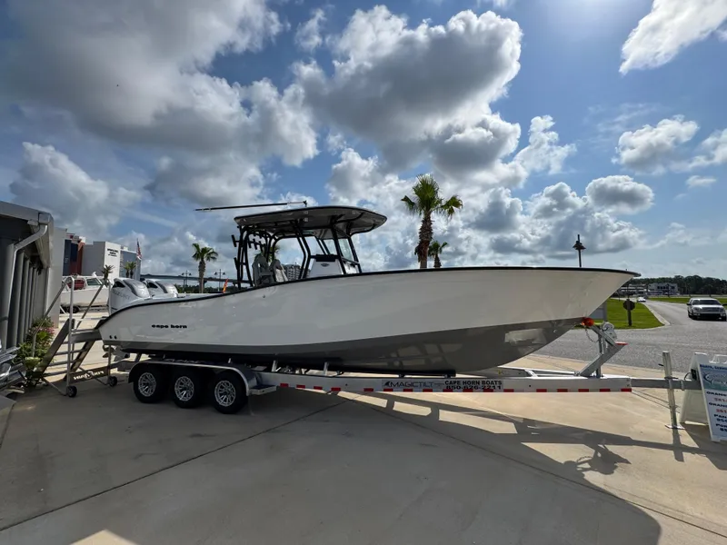 Slide: The Image of 2025 Cape Horn 32 XS boat on trailer under a partly cloudy sky. - 8