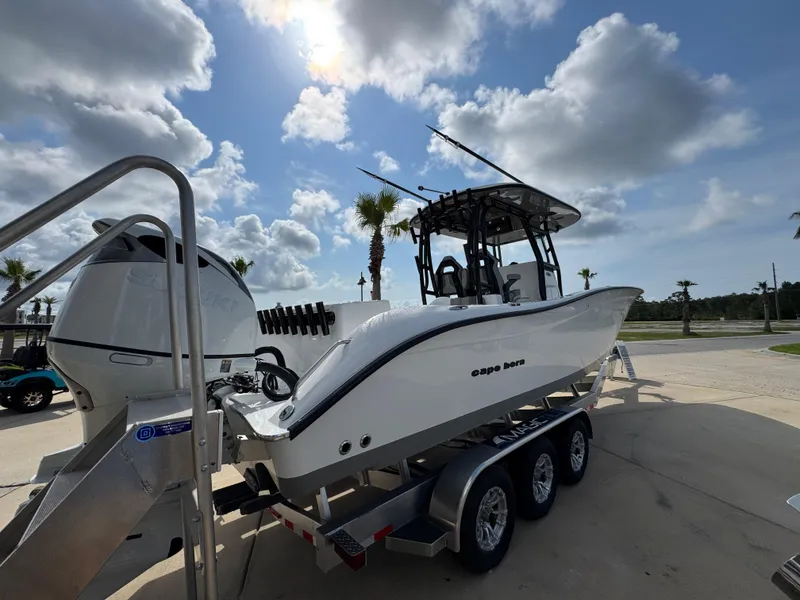 Slide: The Image of 2025 Cape Horn 32 XS boat on trailer under a partly cloudy sky. - 9