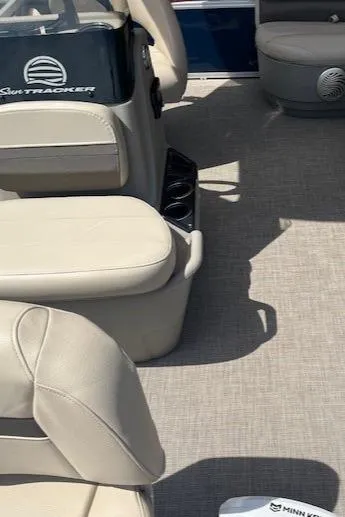 Slide: The Image of 2023 Sun Tracker Bass Buggy 16 XL Select interior with beige seating and cup holders. - 6