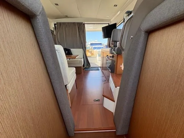 Slide: The Image of Interior of 2013 Jeanneau NC11 yacht with modern furnishings and wood accents. - 11