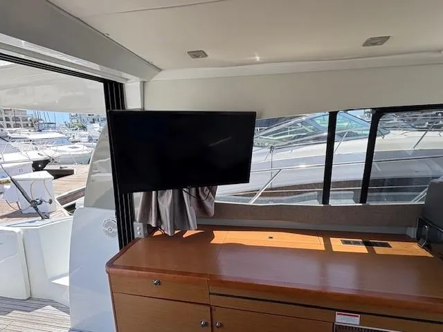 Slide: The Image of Interior of 2013 Jeanneau NC11 yacht with TV and wooden cabinetry. - 4