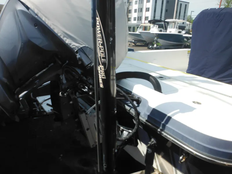 Slide: The Image of 2011 Ranger 2410 Bay Ranger boat with Power-Pole Pro Series, docked outdoors. - 13
