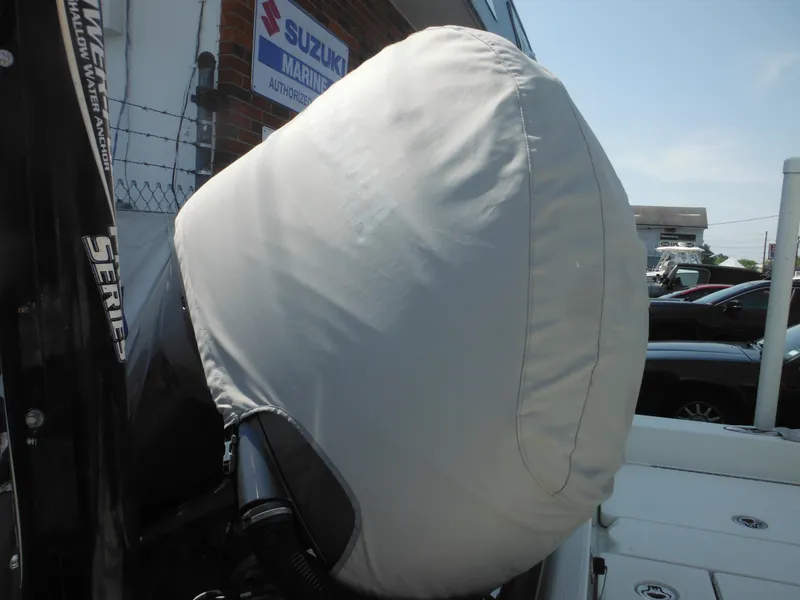 Slide: The Image of 2011 Ranger 2410 Bay Ranger boat engine with protective cover, Suzuki Marine sign in background. - 17