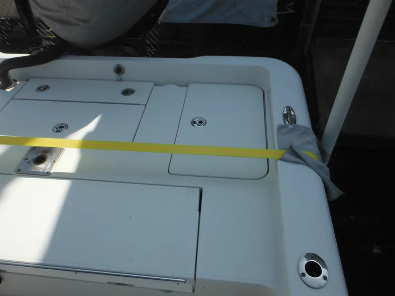 Slide: The Image of 2011 Ranger 2410 Bay Ranger boat deck with storage compartments and yellow strap. - 18