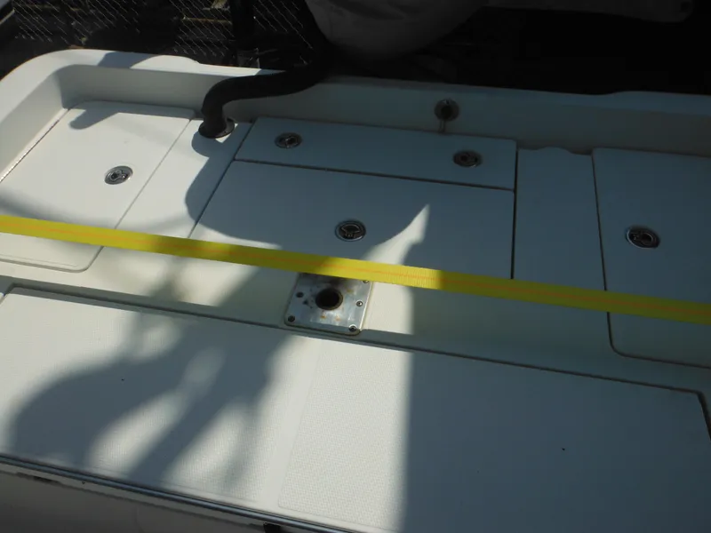 Slide: The Image of 2011 Ranger 2410 Bay Ranger boat deck with storage compartments and yellow strap. - 19