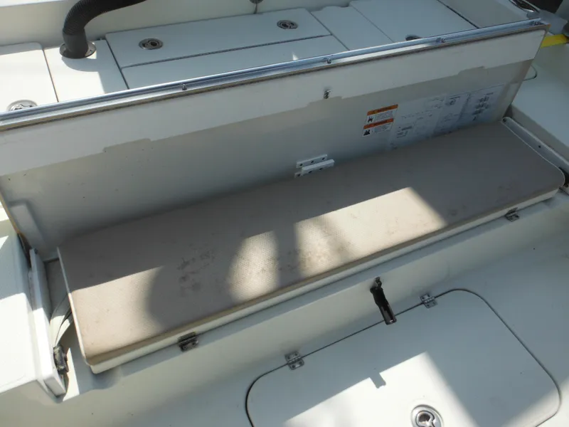 Slide: The Image of 2011 Ranger 2410 Bay Ranger boat storage compartment with cushioned seat. - 23