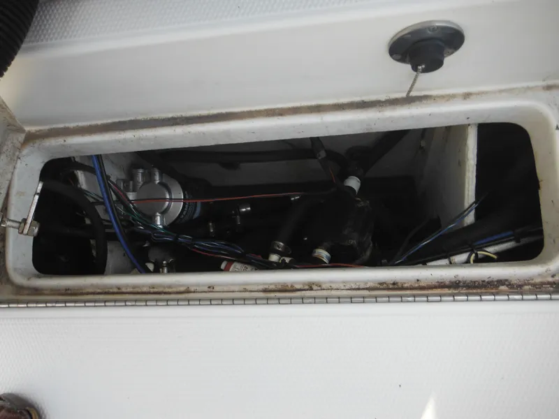 Slide: The Image of 2011 Ranger 2410 Bay Ranger boat compartment with visible wiring and components. - 28