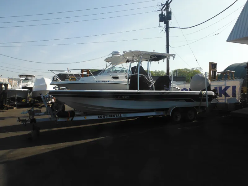 Slide: The Image of 2011 Ranger 2410 Bay Ranger boat on trailer in marina setting. - 3