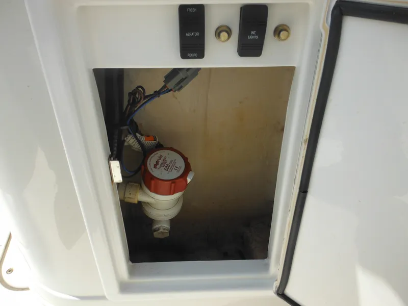Slide: The Image of 2011 Ranger 2410 Bay Ranger boat compartment with wiring and switches. - 32
