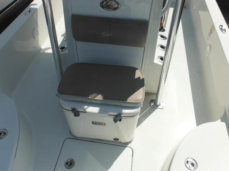 Slide: The Image of 2011 Ranger 2410 Bay Ranger boat interior with cooler seat and storage compartments. - 37