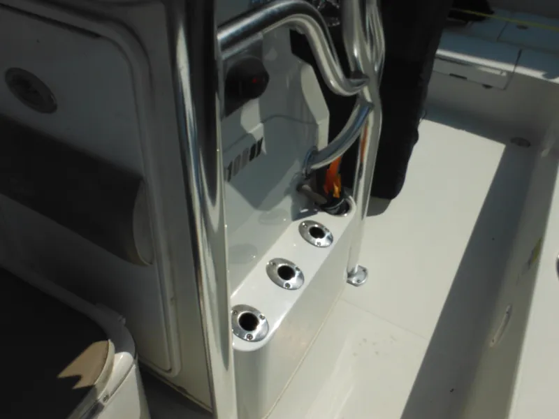 Slide: The Image of 2011 Ranger 2410 Bay Ranger boat console with rod holders and seating area. - 38