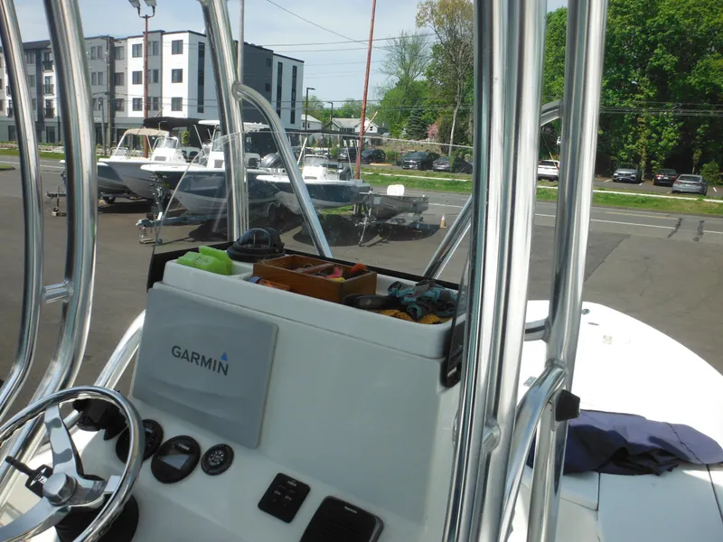 Slide: The Image of 2011 Ranger 2410 Bay Ranger boat with Garmin equipment, docked near other boats and buildings. - 43