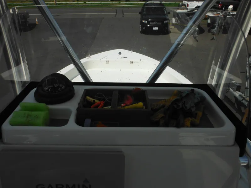 Slide: The Image of 2011 Ranger 2410 Bay Ranger boat dashboard with storage compartments and Garmin equipment. - 47