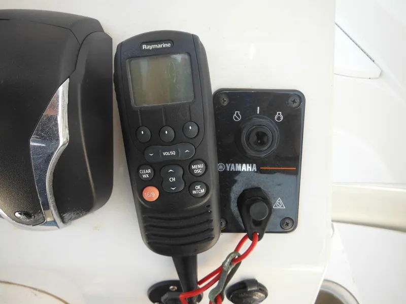 Slide: The Image of Raymarine marine radio and Yamaha control panel on 2011 Ranger 2410 Bay Ranger boat. - 49