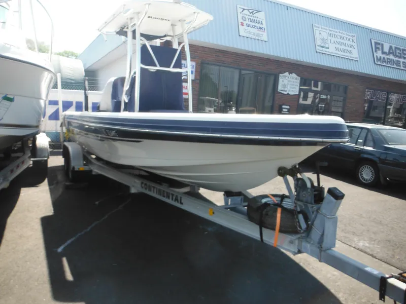 Slide: The Image of 2011 Ranger 2410 Bay Ranger boat on trailer outside marine shop. - 7