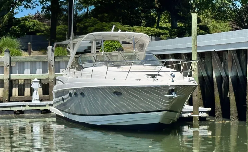 The Image of 2009 Regal Commodore 4060 yacht cruising near scenic coastline. - 1