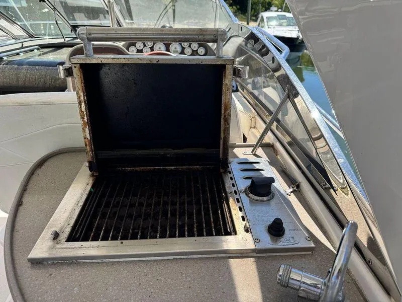 Slide: The Image of Stainless steel grill on 2009 Regal Commodore 4060 yacht deck, featuring control knobs. - 10